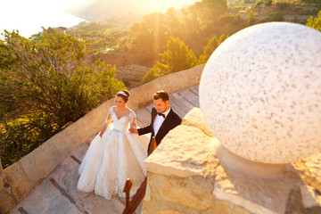 Beautiful wedding couple walking on the  old street. outdoor