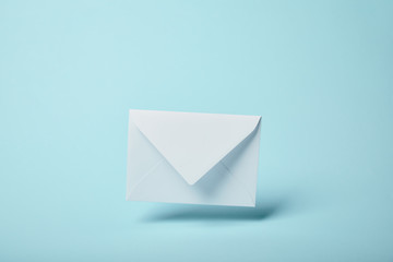 white and blank envelope on blue background with copy space