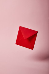 red and bright envelope on pink background with copy space