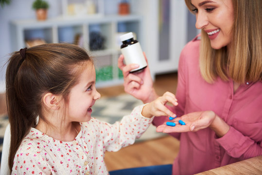 Young Mum Giving Her Little Daughter The Medicine