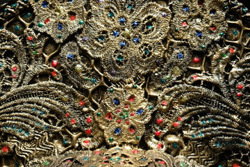 Closeup of details of decorated bronze kokoshnick, dark studio background