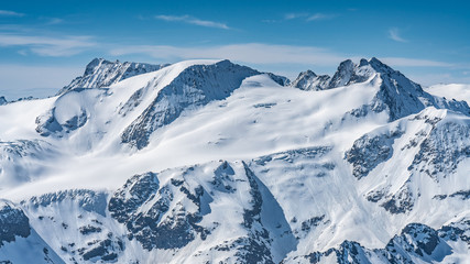 Fototapeta na wymiar Switzerland, panorama view from Titlis mountain on Alps and mountains above white clouds