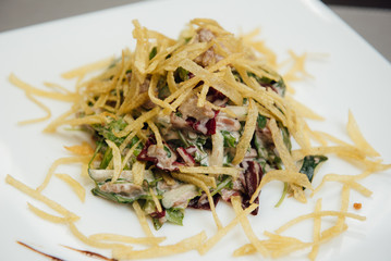maultaschen and greens on a plate on the table