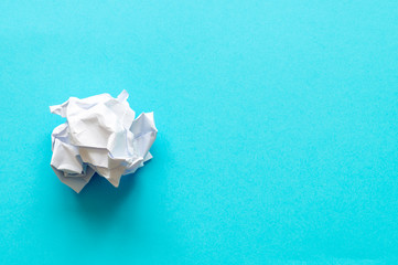 crumpled piece of paper on a blue background