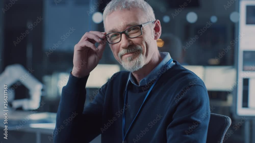 Poster professional electronics design engineer wearing glasses works on laptop in research laboratory, tur
