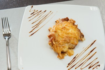 Meat in batter on a white plate on the table