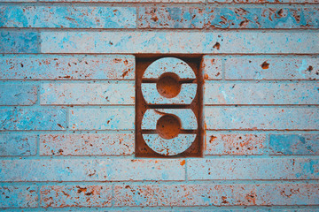 modern number 8 door sign on brick wall