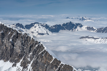 Switzerland, panorama view from Titlis mountain on Alps and mountains above white clouds