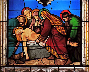 Fototapeta na wymiar 14th Stations of the Cross, Jesus is laid in the tomb and covered in incense, stained glass windows in the Saint Eugene - Saint Cecilia Church, Paris, France 