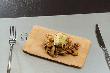 sprat with sauce on a cutting board on the table