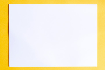 stack of white sheets of paper on multicolored backgrounds top view