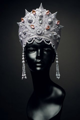 Head of mannequin in creative Russian white kokoshnick with jewels