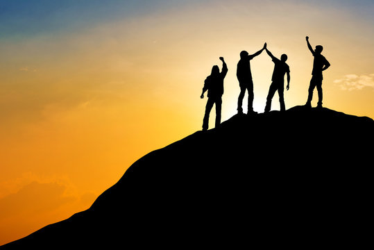 Group of people on peak mountain with sunset background ,team work success business  winner concept