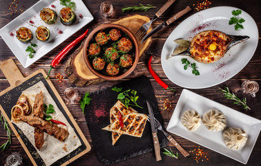 Georgian cuisine. A large laid table of different dishes for the whole family on a day off. Kebab, Lula, Lavash, Suluguni cheese, Khachipuri, Khinkali.