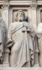 Fototapeta na wymiar Saint Paul the Apostle, statue on the facade of Saint Augustine church in Paris, France
