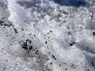 Thawed patch in the snow. Melting snow. Spring, slush, melted snow