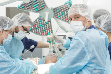 Professional surgeons during operation in surgery room