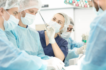 Team of surgeons performing surgery in operation room