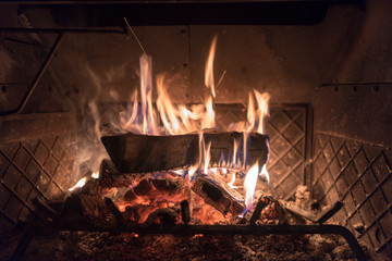 a log on fire inside of a wood burning stove