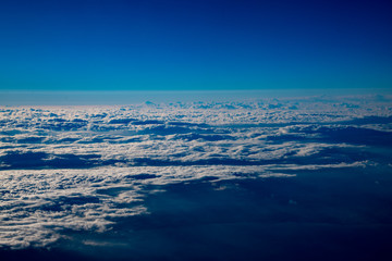 Fototapeta premium 高空より雲間に海や地上が覗く風景が美しい