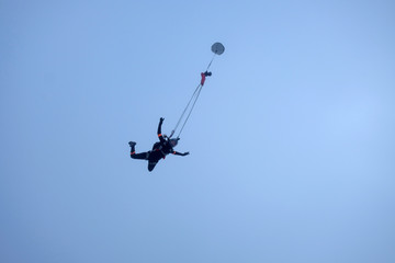 The deployment of a parachute in the sky.