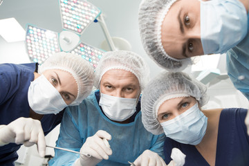 Professional surgical team preparing for operation point of view of patient - obrazy, fototapety, plakaty