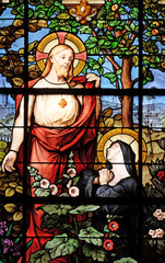 Obraz premium Apparition of the Sacred Heart to Marguerite Marie Alacoque, stained glass windows in the Saint Gervais and Saint Protais Church, Paris, France