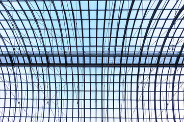 Under the roof. Glass panel roof with white battens under bright blue sky