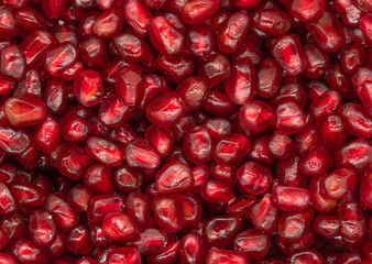 Texture of red peeled pomegranate background