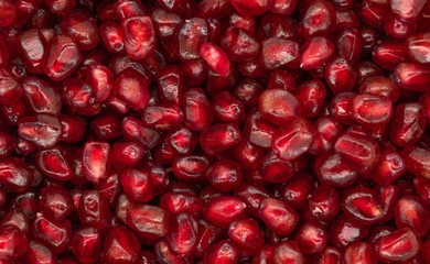 Texture of red peeled pomegranate background