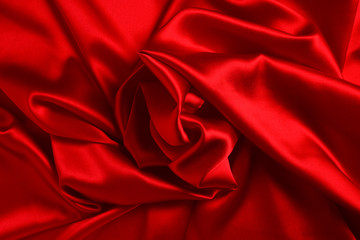 Red silk or satin luxury fabric texture can use as abstract background. Top view.