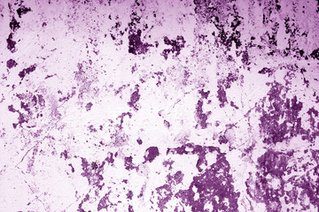Сraked weathered cement wall texture in purple tone.