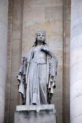 Fototapeta na wymiar Saint Clotilde, statue on the portal of Saint Roch church in Paris, France 