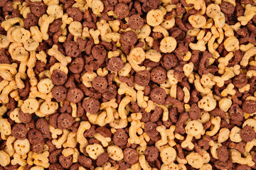  Chocolate flakes in the form of skulls and bones background. Top view.