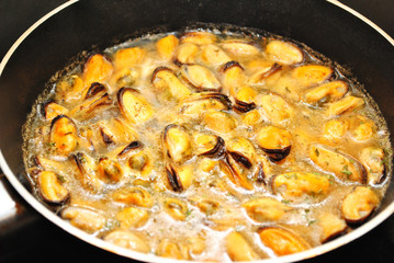 Fresh Mussels Cooking in Wine, Butter & Garlic Sauce