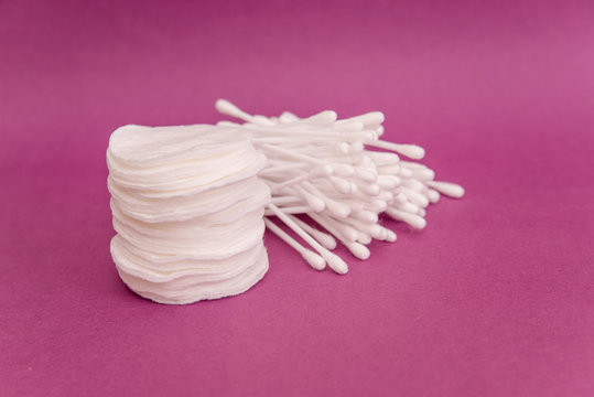 cotton pad and cotton buds on pink background