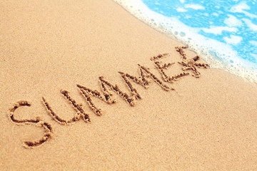 Summer concept with sea beach. Sand and blue surf texture background. Season and holiday