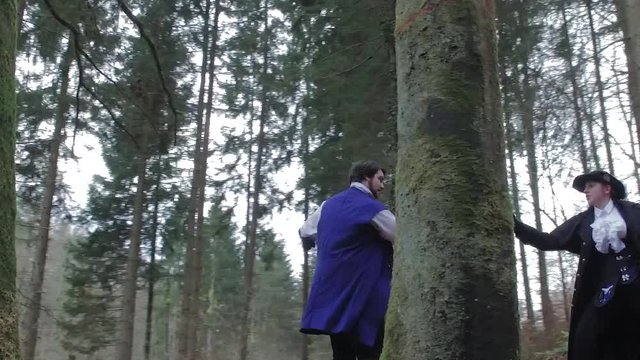 Two musketeers in forest behind tree – slow motion