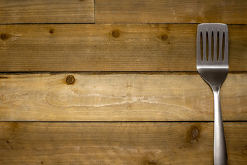 BBQ Spatula on rustic weathered wood background