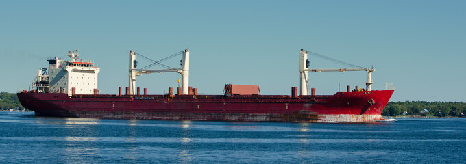 Panorama of a lone frieght ship on the St. Lawrence Seaway