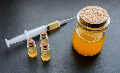 Orange liquid in a glass jar. Selective focus and shallow depth of field.
