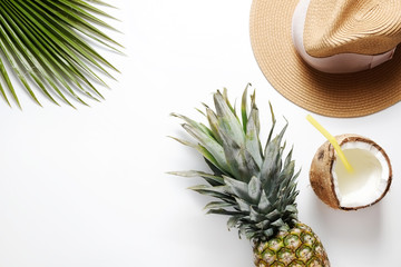 Summer mood concept. Tropical background with ripe organic pinapple with leafy crown, cracked...