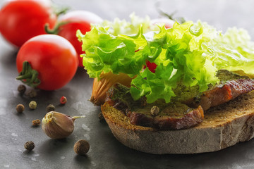 Vegetables. Close-up of lettuce, tomatoes, bread, roast beef, garlic and spices.