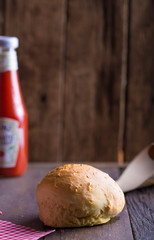 Burger bun on wooden  background.