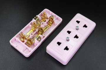 power outlet adapter what's inside, isolated on black studio background