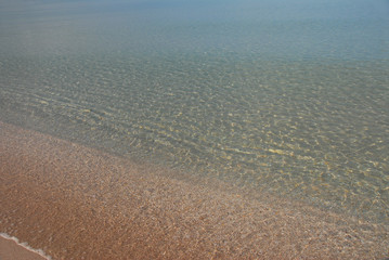 The quiet expanse of the sea, so well lit by sunlight, that the bottom is visible in shallow water. Very beautiful transition from light yellow sand to turquoise on the horizon.