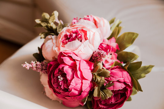 Bouquet of beautiful red artificial peonies.Horizontal photo