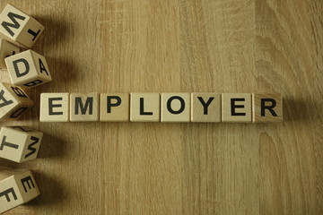 Employer word from wooden blocks on desk