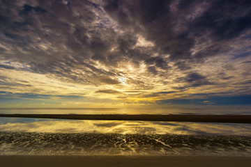 Naklejka na ściany i meble Beautiful tropical sea sky and sand reflection of a sunrise