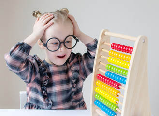 Caucasian little girl with round glasses. Little teacher. Funny glasses humor. Retro style